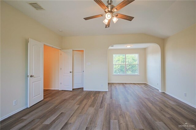 unfurnished bedroom with ceiling fan, lofted ceiling, and hardwood / wood-style flooring