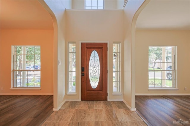 entryway with a towering ceiling and a wealth of natural light