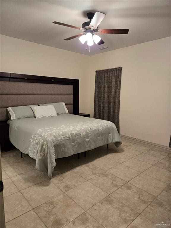 tiled bedroom with ceiling fan