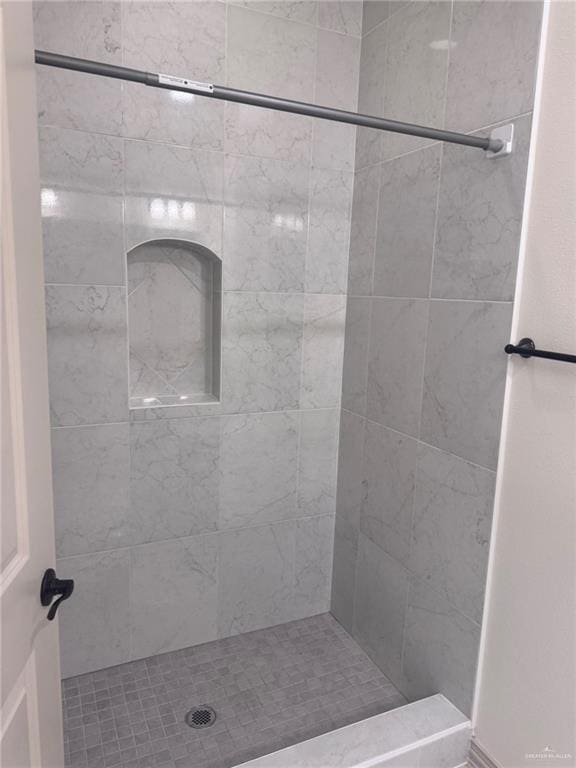 bathroom with a tile shower