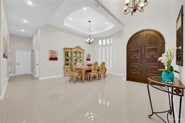 1410 Lobelia St, Weslaco, TX 78599 - dining area featuring a chandelier, light tile patterned floors, recessed lighting, and a tray ceiling