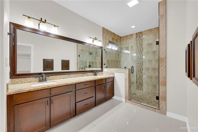 1410 Lobelia St, Weslaco, TX 78599 - bathroom with a shower stall, double vanity, and tile patterned floors