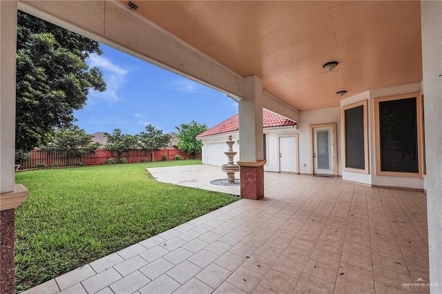 1410 Lobelia St, Weslaco, TX 78599 - view of patio featuring a garage and driveway