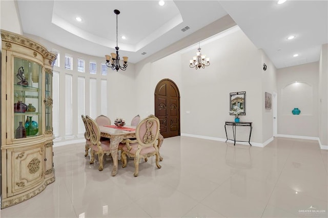 1410 Lobelia St, Weslaco, TX 78599 - dining area with a chandelier, light tile patterned flooring, recessed lighting, and a tray ceiling