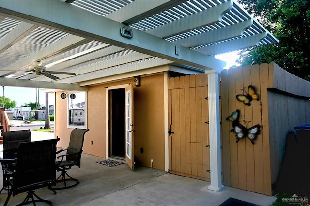 view of patio featuring a pergola, outdoor dining space, and ceiling fan