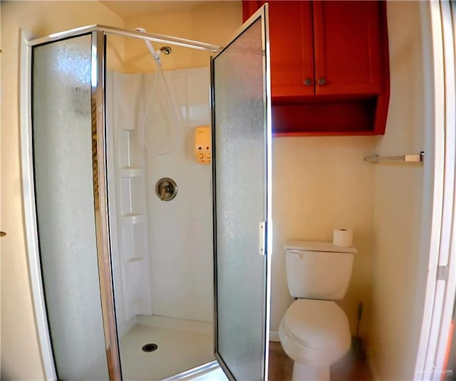 full bathroom with toilet and a stall shower