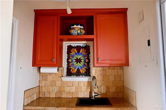 kitchen with a sink and tasteful backsplash