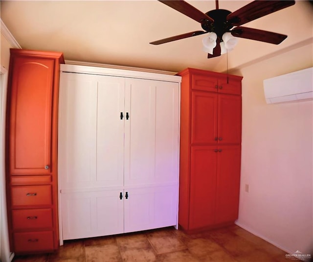 unfurnished bedroom featuring a wall mounted AC, a closet, baseboards, and ceiling fan
