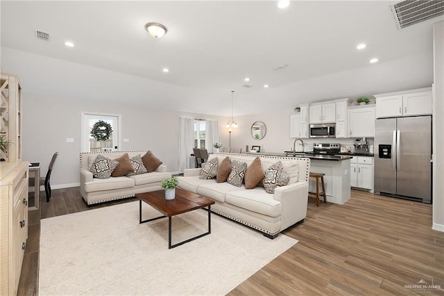 7719 N 39th Ln, Mcallen, TX 78504 - living area with wood finished floors, baseboards, and recessed lighting
