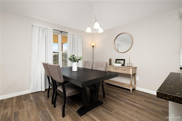 7719 N 39th Ln, Mcallen, TX 78504 - dining area featuring dark wood-style floors, baseboards, and a chandelier