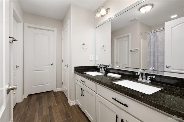 7719 N 39th Ln, Mcallen, TX 78504 - bathroom featuring double vanity, wood finished floors, baseboards, and curtained shower