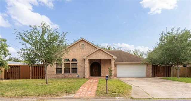 view of front of house with a garage and a front yard