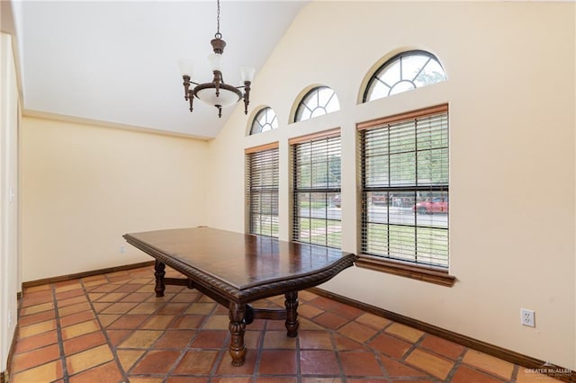 tiled dining area featuring an inviting chandelier, high vaulted ceiling, and a wealth of natural light