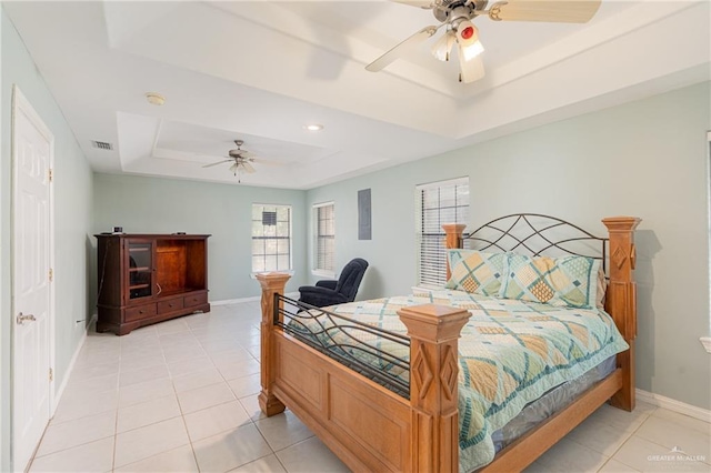 bedroom with a raised ceiling, ceiling fan, and light tile patterned flooring