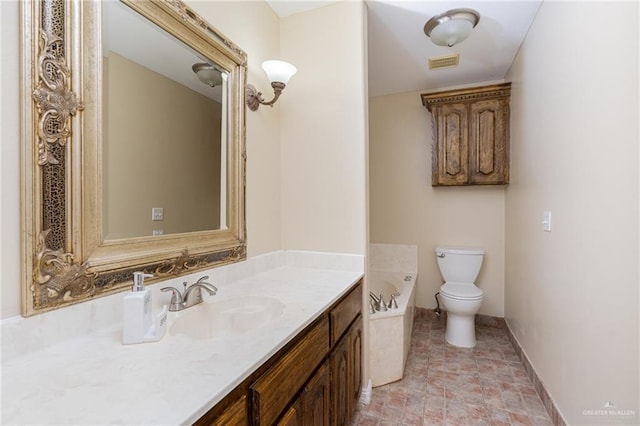 bathroom featuring vanity, a bath, and toilet