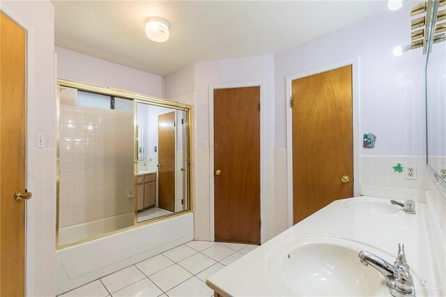 2915 Roselawn Dr, Weslaco, TX 78596 - bathroom with double vanity, tile patterned flooring, and enclosed tub / shower combo