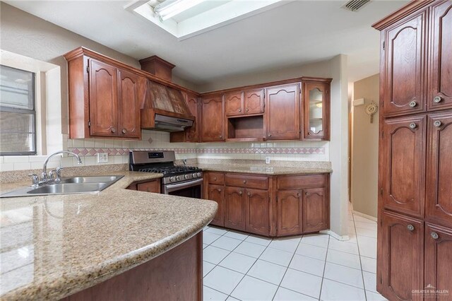 2915 Roselawn Dr, Weslaco, TX 78596 - kitchen with gas range, backsplash, light tile patterned flooring, light countertops, and under cabinet range hood