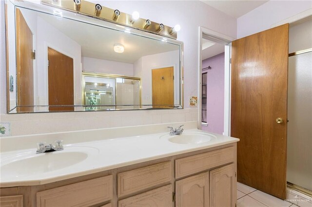 2915 Roselawn Dr, Weslaco, TX 78596 - full bathroom featuring double vanity, a stall shower, and tile patterned floors