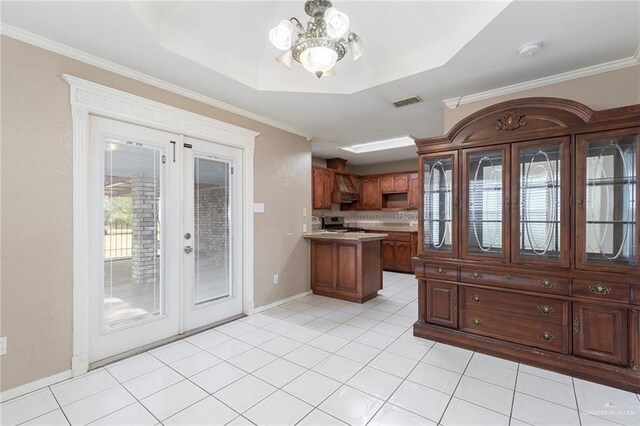 2915 Roselawn Dr, Weslaco, TX 78596 - kitchen with french doors, a chandelier, a peninsula, stove, and light countertops