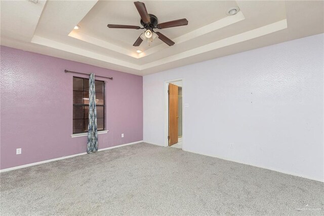 2915 Roselawn Dr, Weslaco, TX 78596 - spare room with a tray ceiling, ceiling fan, and carpet flooring