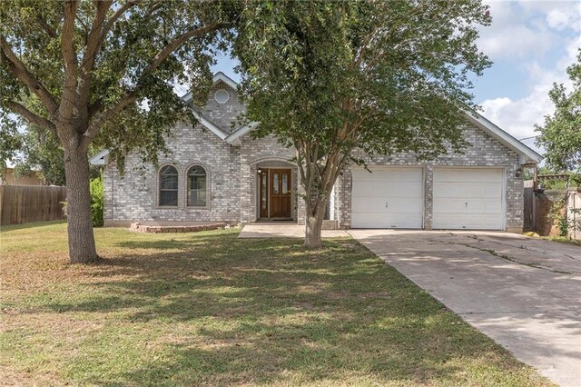 2915 Roselawn Dr, Weslaco, TX 78596 - view of front facade with an attached garage, brick siding, and concrete driveway