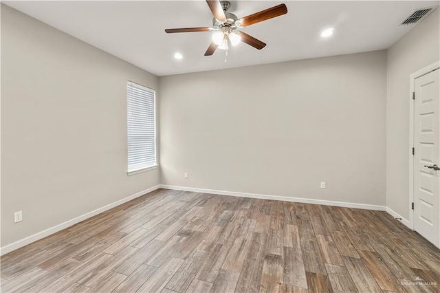 unfurnished room with ceiling fan and light hardwood / wood-style floors