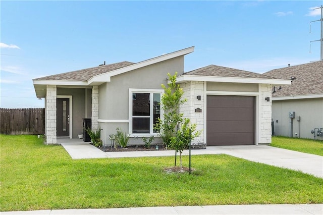 single story home featuring a garage and a front lawn