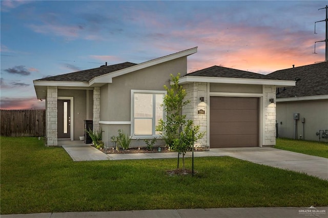 view of front facade featuring a yard and a garage