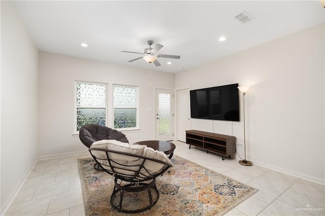 living room with light tile patterned flooring, a wealth of natural light, and ceiling fan