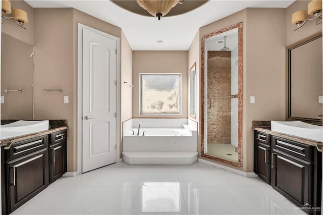 bathroom with tile patterned floors, vanity, and independent shower and bath