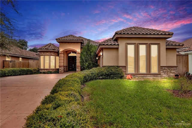 mediterranean / spanish-style house featuring a yard