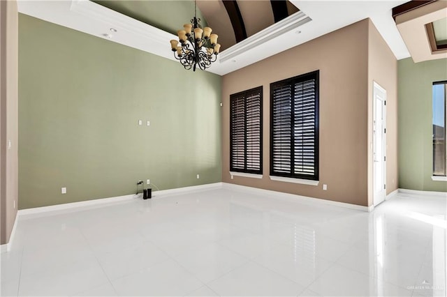 empty room featuring tile patterned flooring, a notable chandelier, beam ceiling, and plenty of natural light