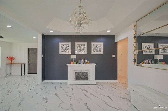 living room with a raised ceiling and an inviting chandelier