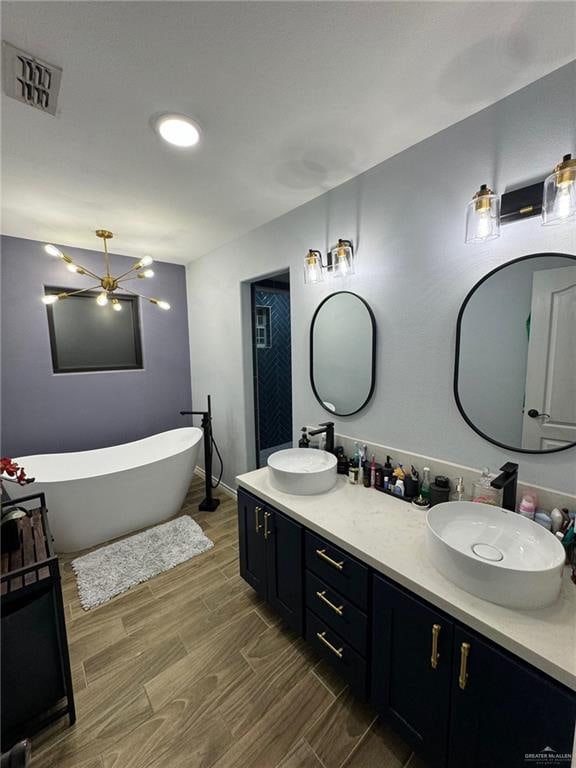 bathroom featuring wood-type flooring, vanity, and a bathing tub