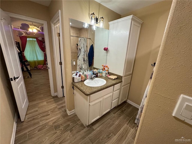 bathroom featuring vanity, wood-type flooring, and walk in shower