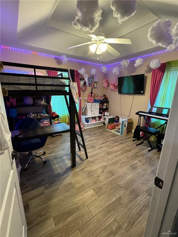 bedroom featuring hardwood / wood-style flooring and ceiling fan