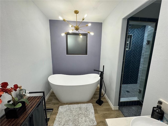 bathroom featuring hardwood / wood-style floors, vanity, independent shower and bath, and a chandelier