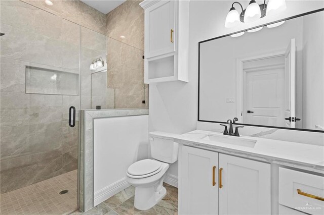 bathroom featuring vanity, toilet, and an enclosed shower