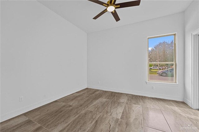 empty room featuring ceiling fan and lofted ceiling