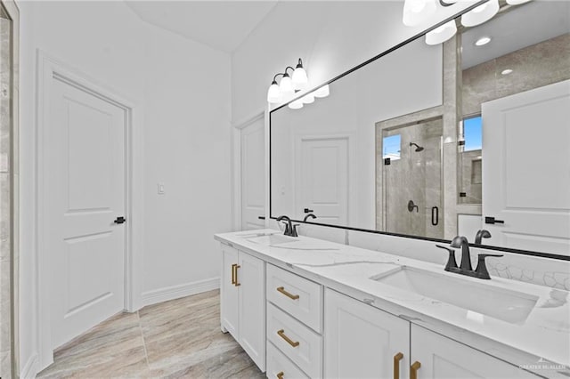 bathroom featuring vanity and a shower with shower door