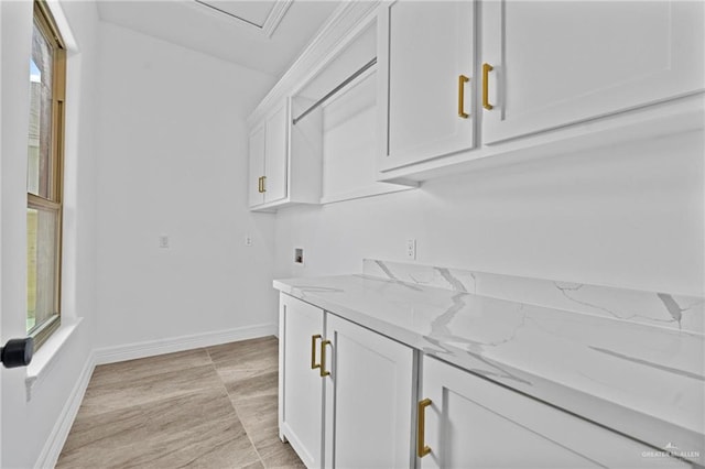 bar featuring white cabinetry and light stone counters