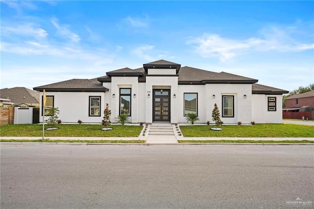 prairie-style home with a front yard and french doors