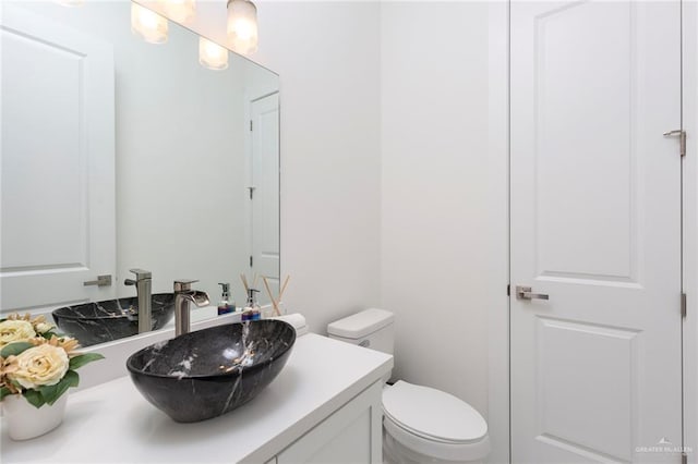 bathroom featuring toilet and vanity