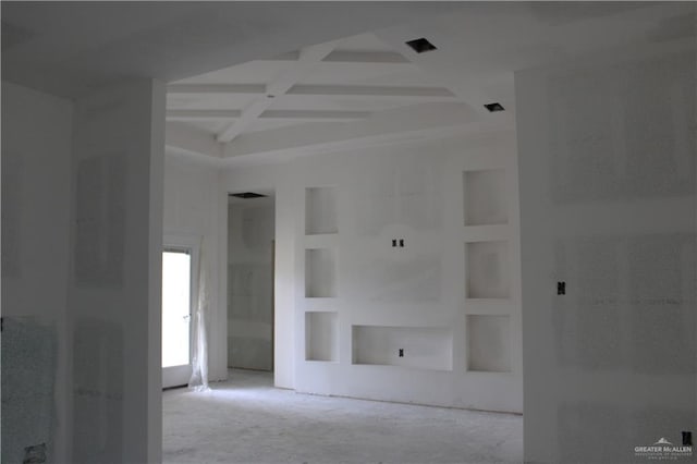 unfurnished room featuring beamed ceiling, coffered ceiling, and built in features