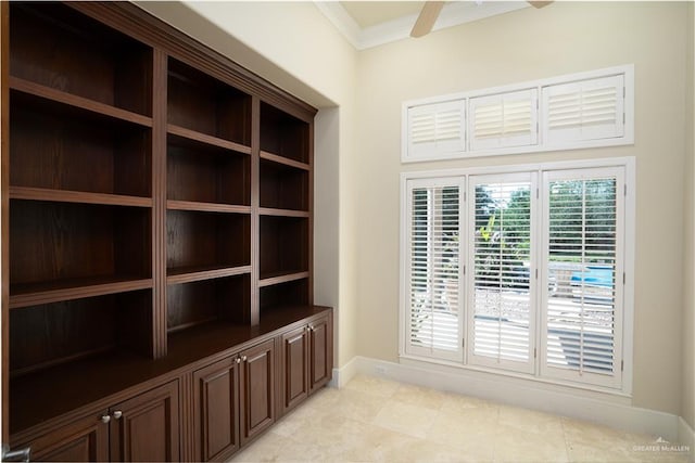 unfurnished room featuring ceiling fan and ornamental molding