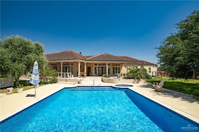 view of swimming pool featuring an in ground hot tub, a patio, and french doors