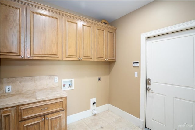 clothes washing area featuring electric dryer hookup, light tile patterned flooring, cabinets, and washer hookup