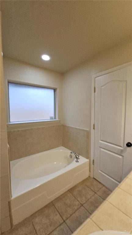 bathroom featuring tile patterned flooring and a bathing tub