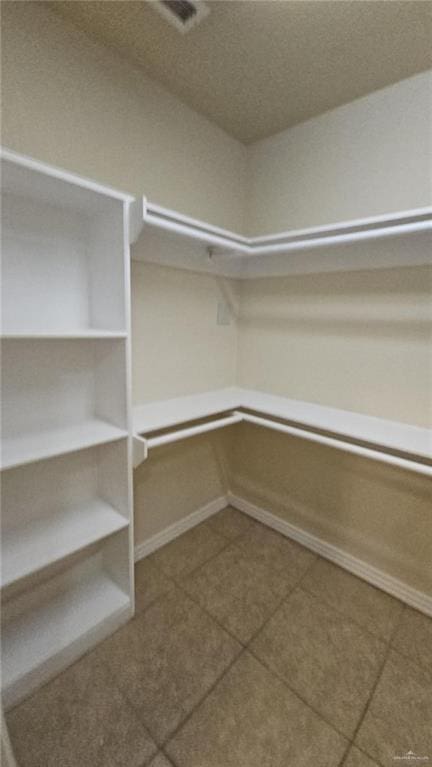 spacious closet with tile patterned floors