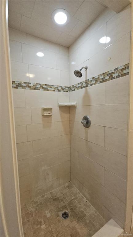 bathroom with tiled shower